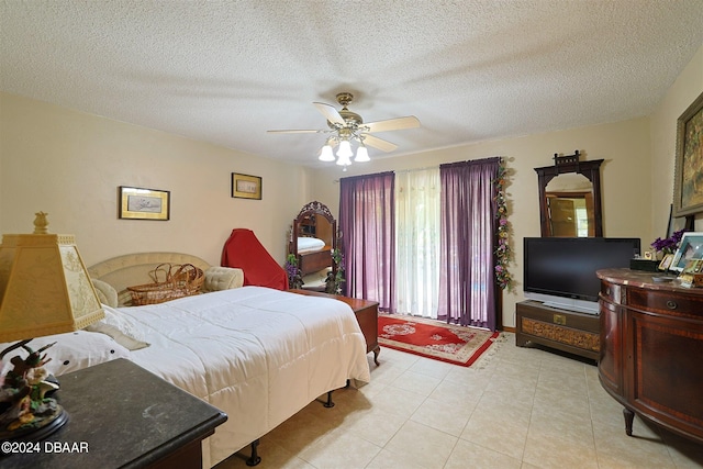 bedroom with light tile patterned flooring, ceiling fan, and a textured ceiling