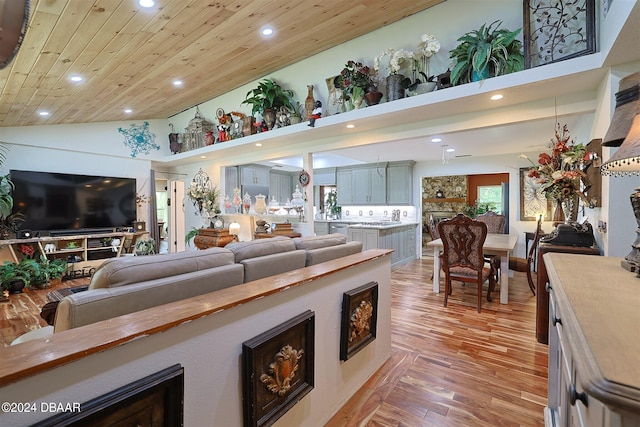 living room with wooden ceiling, light wood-type flooring, and high vaulted ceiling