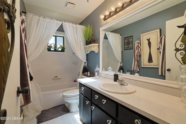 full bathroom featuring toilet, tile patterned flooring, a textured ceiling, vanity, and shower / tub combo with curtain