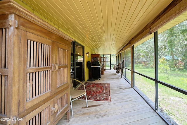 unfurnished sunroom with wooden ceiling