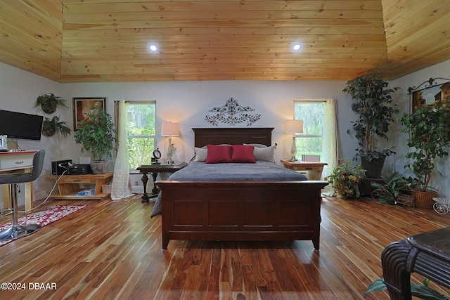 bedroom featuring wooden ceiling, wood-type flooring, multiple windows, and high vaulted ceiling