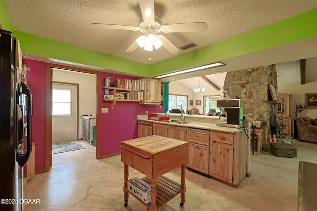 kitchen featuring kitchen peninsula, sink, vaulted ceiling with beams, and plenty of natural light