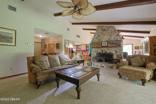 tiled living room featuring a textured ceiling, lofted ceiling with beams, ceiling fan, and a stone fireplace