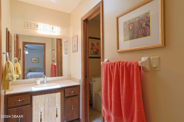 bathroom with vanity, ceiling fan, and toilet