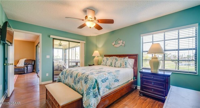 17230 Terraverde Cir Unit 7, Fort Myers, FL 33908 - bedroom featuring wood finished floors, baseboards, a textured ceiling, access to exterior, and ceiling fan
