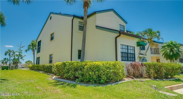 17230 Terraverde Cir Unit 7, Fort Myers, FL 33908 - view of side of home featuring stucco siding, a lawn, and central air condition unit