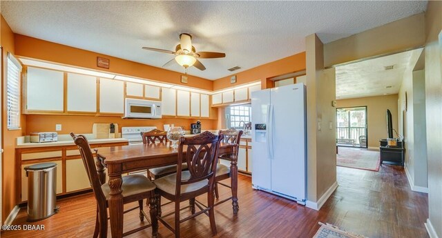 17230 Terraverde Cir Unit 7, Fort Myers, FL 33908 - dining room featuring dark wood-style floors, a ceiling fan, healthy amount of natural light, and a textured ceiling