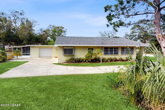 single story home with a shingled roof, concrete driveway, an attached garage, a front yard, and stucco siding