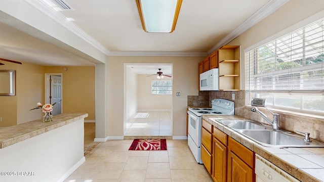 kitchen featuring decorative backsplash, ornamental molding, light tile patterned flooring, a sink, and white appliances