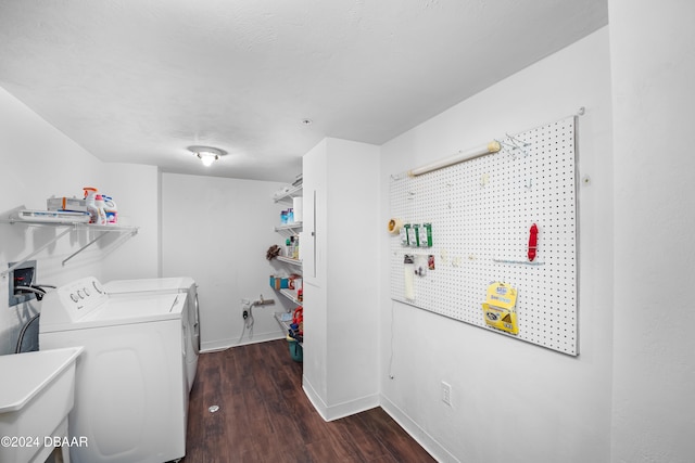 clothes washing area featuring dark hardwood / wood-style floors, sink, and washer and dryer