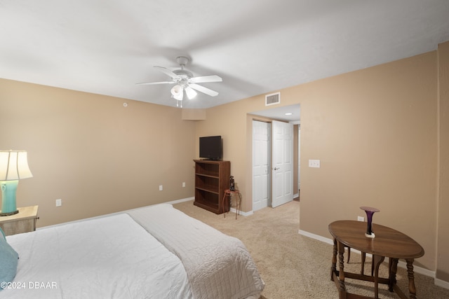 bedroom with ceiling fan and light colored carpet