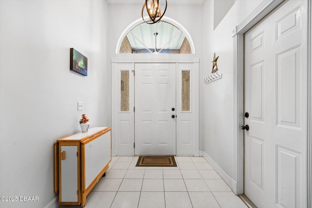 entryway featuring an inviting chandelier and light tile patterned floors