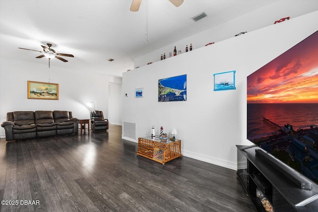 living room featuring ceiling fan and dark hardwood / wood-style flooring