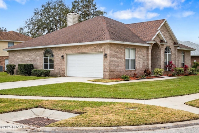 view of front of home with a garage and a front yard