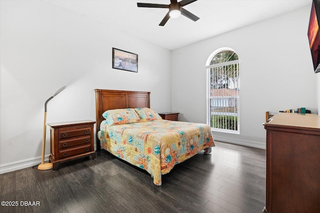 bedroom featuring multiple windows, dark hardwood / wood-style floors, and ceiling fan