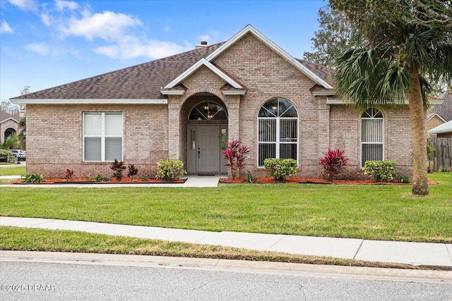 ranch-style home with a front lawn