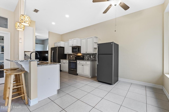 kitchen with sink, tasteful backsplash, black appliances, kitchen peninsula, and white cabinets