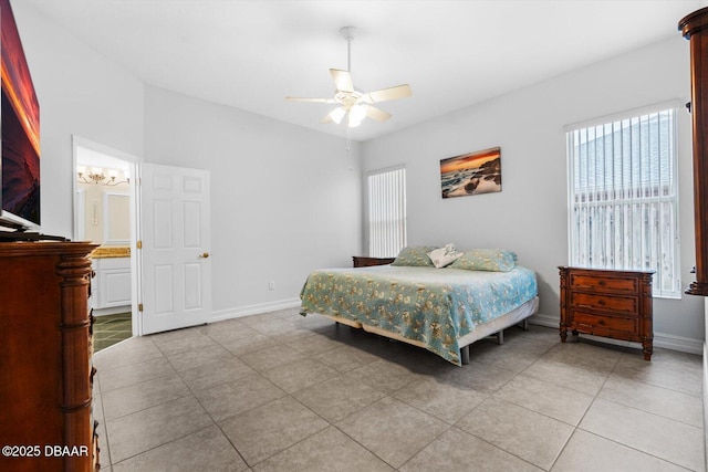 tiled bedroom featuring ceiling fan and ensuite bath