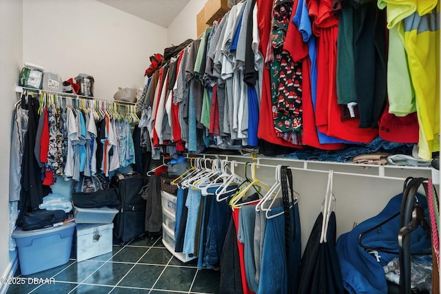 spacious closet featuring dark tile patterned floors