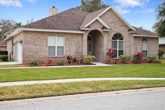 view of front of home with a garage and a front yard