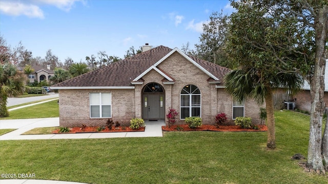 view of front of home featuring cooling unit and a front lawn