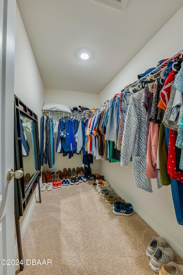 walk in closet featuring carpet