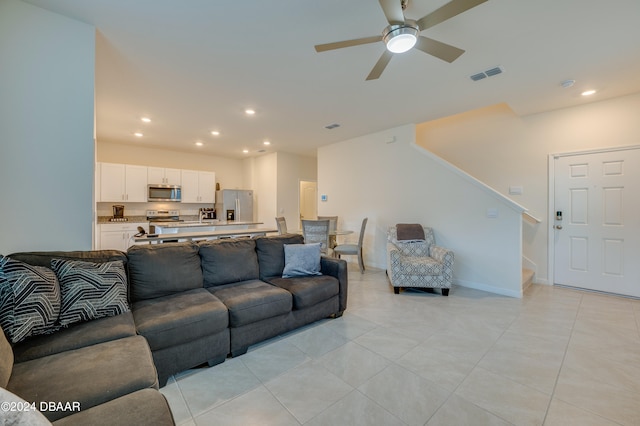 tiled living room featuring ceiling fan