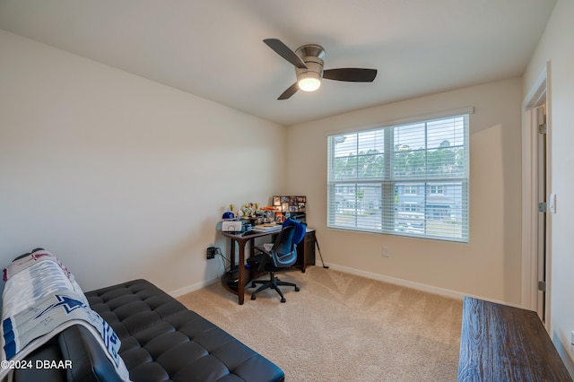 carpeted office space featuring ceiling fan