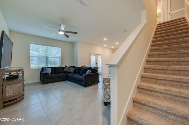 tiled living room with french doors and ceiling fan