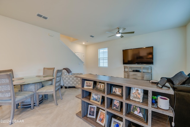 living room with ceiling fan and light tile patterned floors