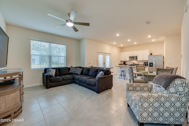 tiled living room featuring ceiling fan and a healthy amount of sunlight