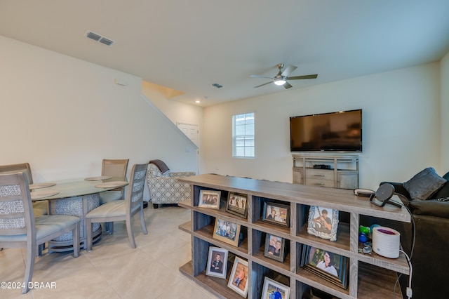 tiled living room with ceiling fan and visible vents