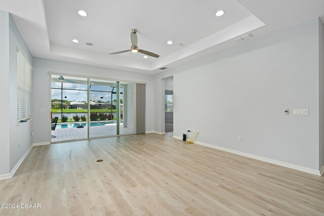 798 Jollymon Way, Daytona Beach, FL 32124 - spare room featuring a raised ceiling, ceiling fan, plenty of natural light, light wood-style floors, and recessed lighting