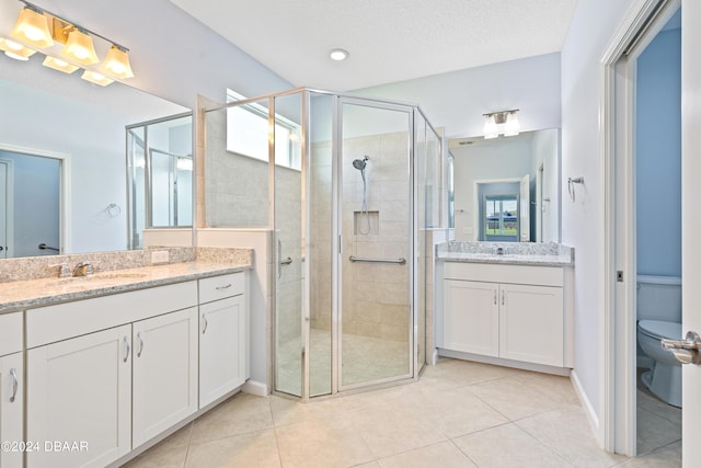 bathroom featuring a sink, a shower stall, and tile patterned floors