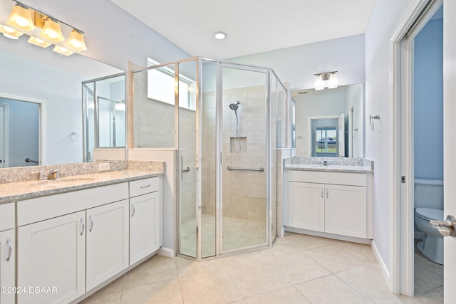 798 Jollymon Way, Daytona Beach, FL 32124 - full bathroom featuring a shower stall, two vanities, tile patterned flooring, and toilet