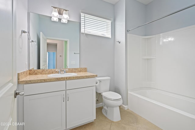 bathroom featuring tile patterned flooring, toilet, vanity, baseboards, and tub / shower combination