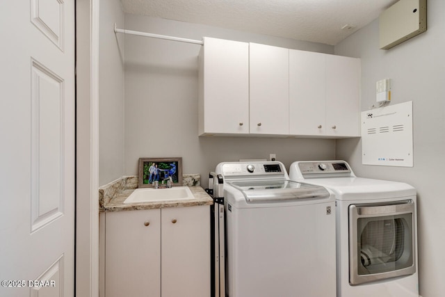 1245 Hampstead Ln, Ormond Beach, FL 32174 - laundry room with cabinet space, separate washer and dryer, and a textured ceiling