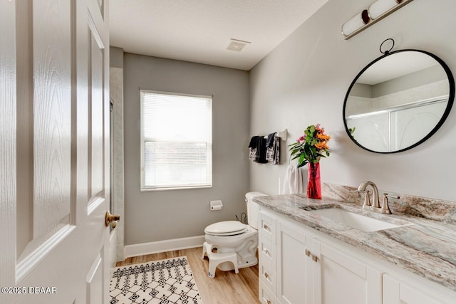 1245 Hampstead Ln, Ormond Beach, FL 32174 - bathroom featuring vanity, toilet, wood finished floors, a shower, and baseboards