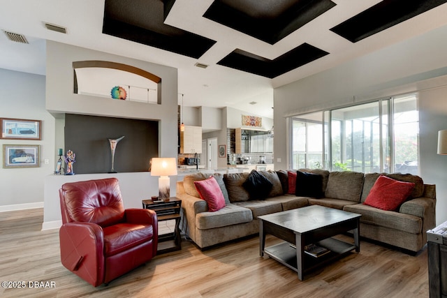 1245 Hampstead Ln, Ormond Beach, FL 32174 - living room featuring light wood-style flooring, baseboards, and a high ceiling