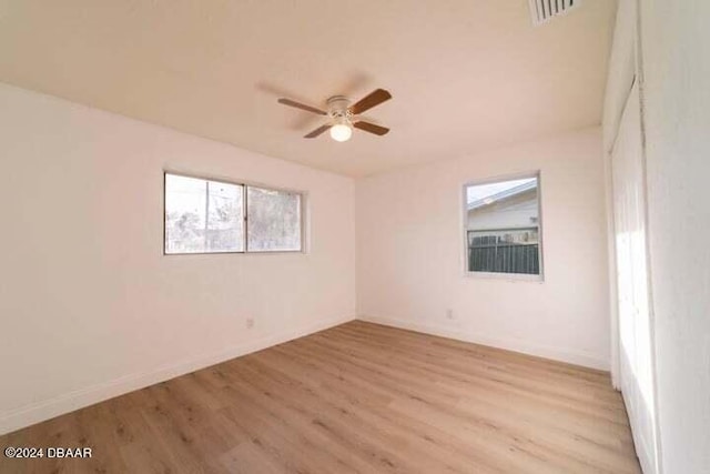 empty room with ceiling fan and light wood-type flooring