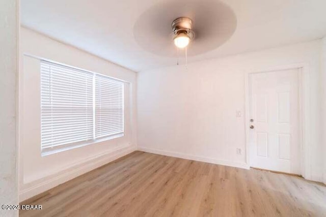 spare room with light hardwood / wood-style flooring and ceiling fan