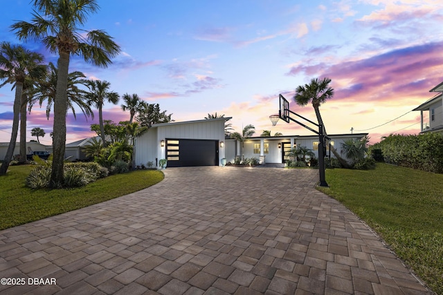 view of front facade with a garage and a yard