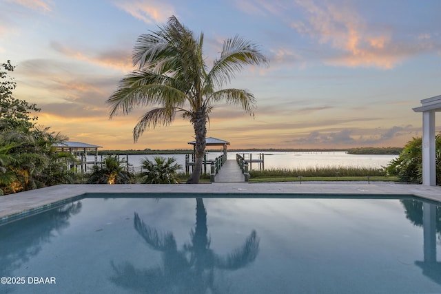 pool at dusk with a water view