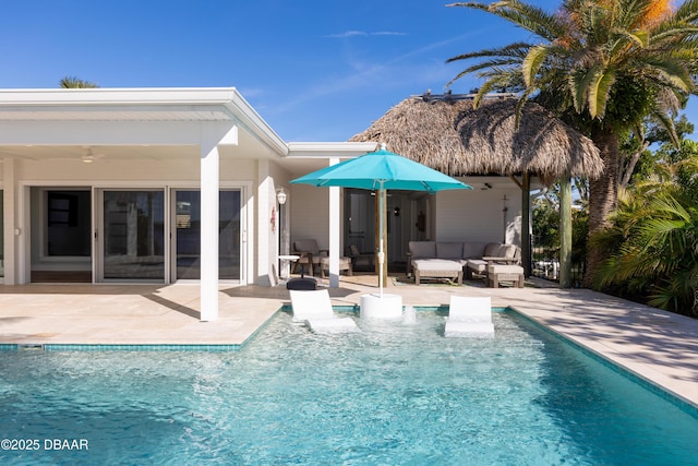 back of house with ceiling fan, outdoor lounge area, and a patio