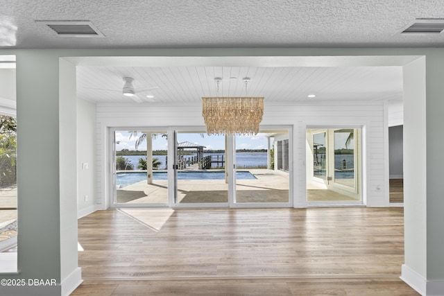 empty room with light hardwood / wood-style floors and ceiling fan