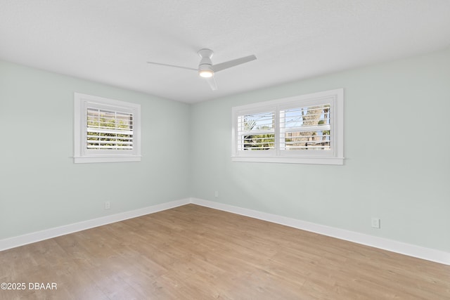 unfurnished room with ceiling fan, light hardwood / wood-style flooring, and a textured ceiling