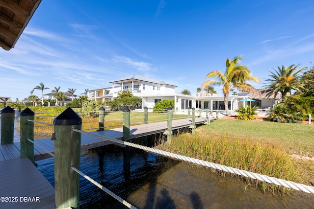 dock area featuring a water view and a yard