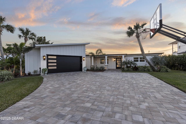 contemporary house featuring a garage and a yard