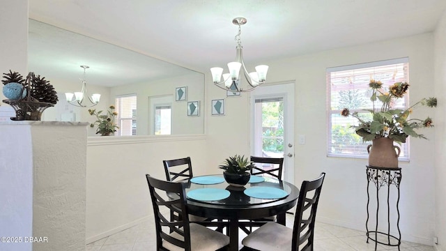 52 Palm Dr, Ormond Beach, FL 32176 - dining room featuring a chandelier, plenty of natural light, and light tile patterned floors