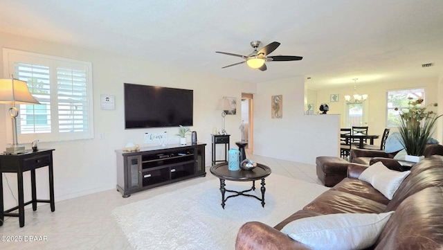 52 Palm Dr, Ormond Beach, FL 32176 - living room featuring a chandelier, ceiling fan, and light tile patterned flooring
